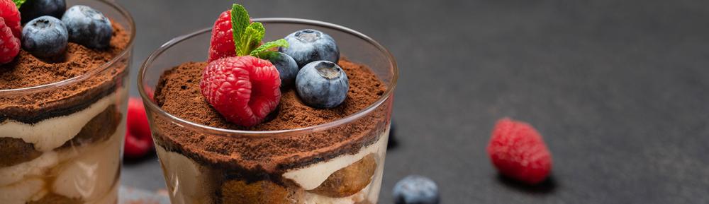 A tiramisu with raspberries and blueberries on top