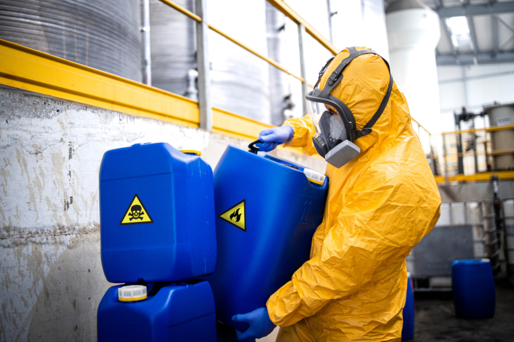 person in hazmat suit transporting chemicals