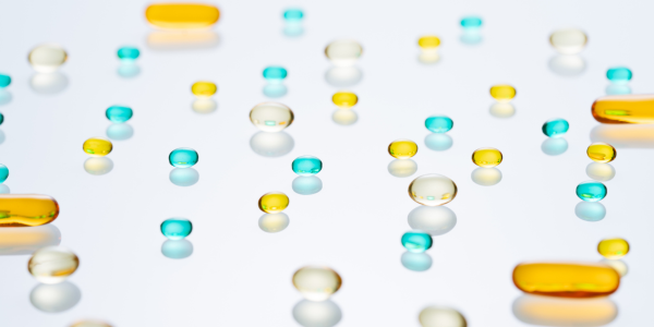 yellow, clear and blue colored gel pills on a transparent background