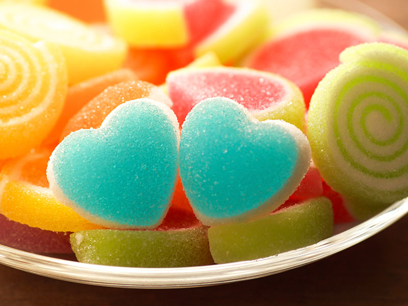 A selection of confectionery including two blue heart shaped sweets