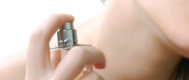 Woman applying perfume