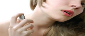 Woman applying perfume